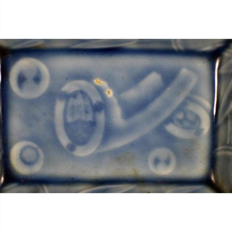 White porcelain dish with hand painted abstract raised white designs and circular patterns, vintage Asian style.