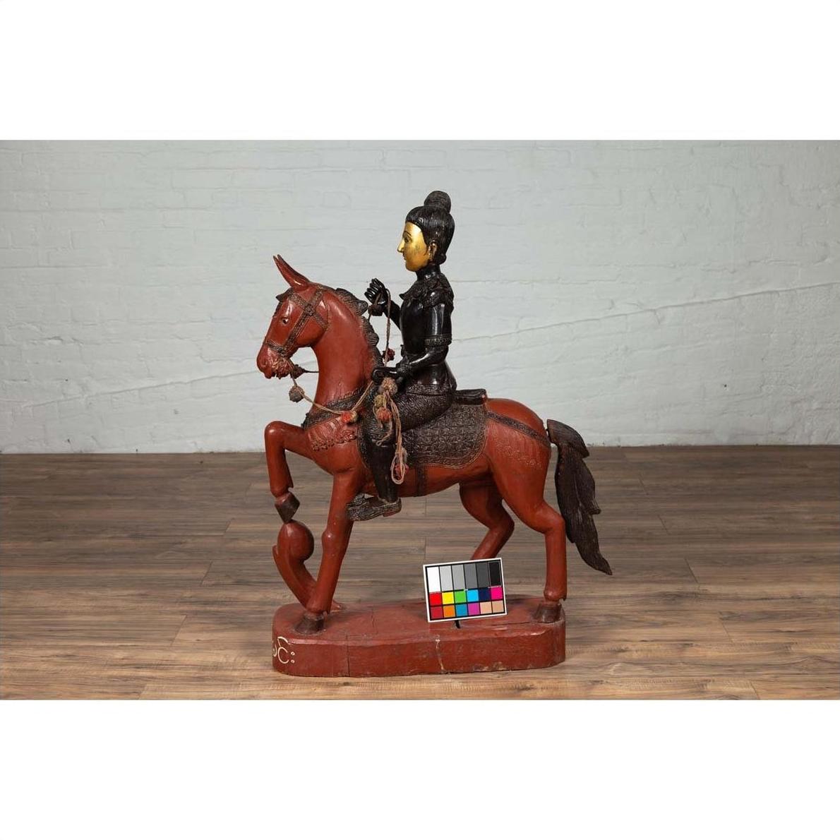 Polychrome carved wooden statue of a Burmese warrior riding a horse, vintage style, close-up view.