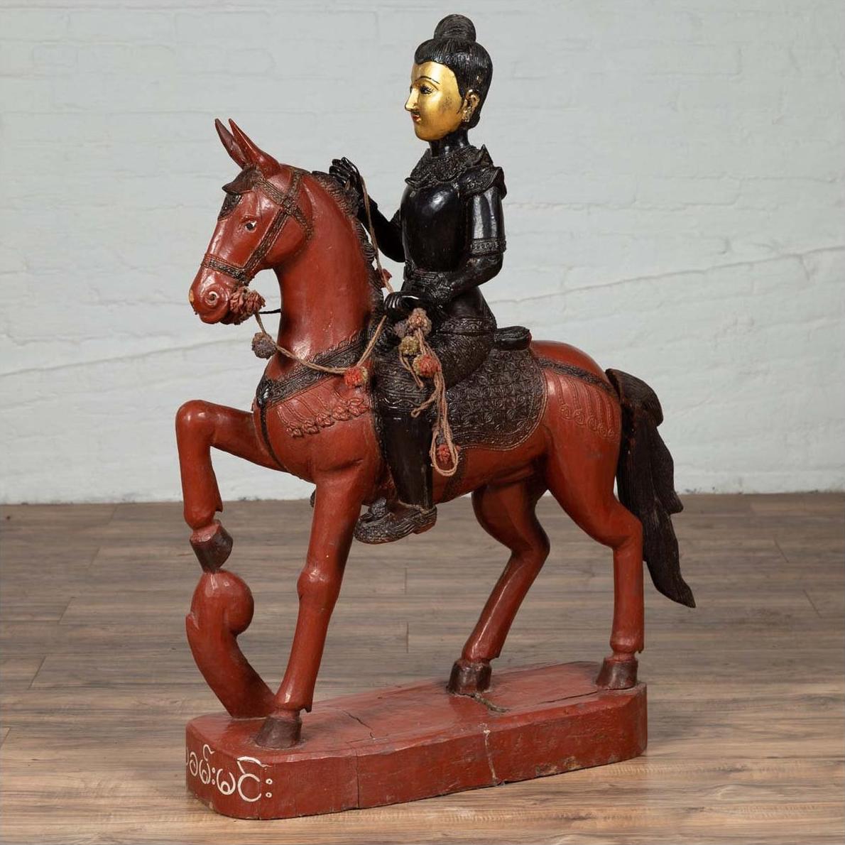 Polychrome wooden Burmese warrior statue on horseback, vintage style, mounted on a wooden base.