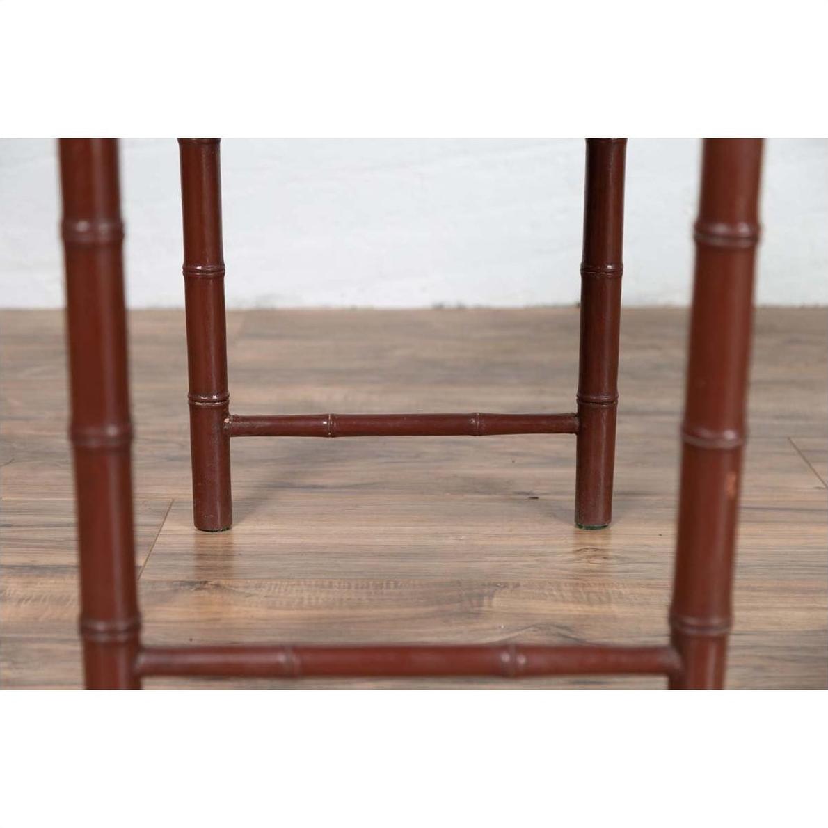 Close-up of brown bamboo table legs with a vintage patina on wooden floor.