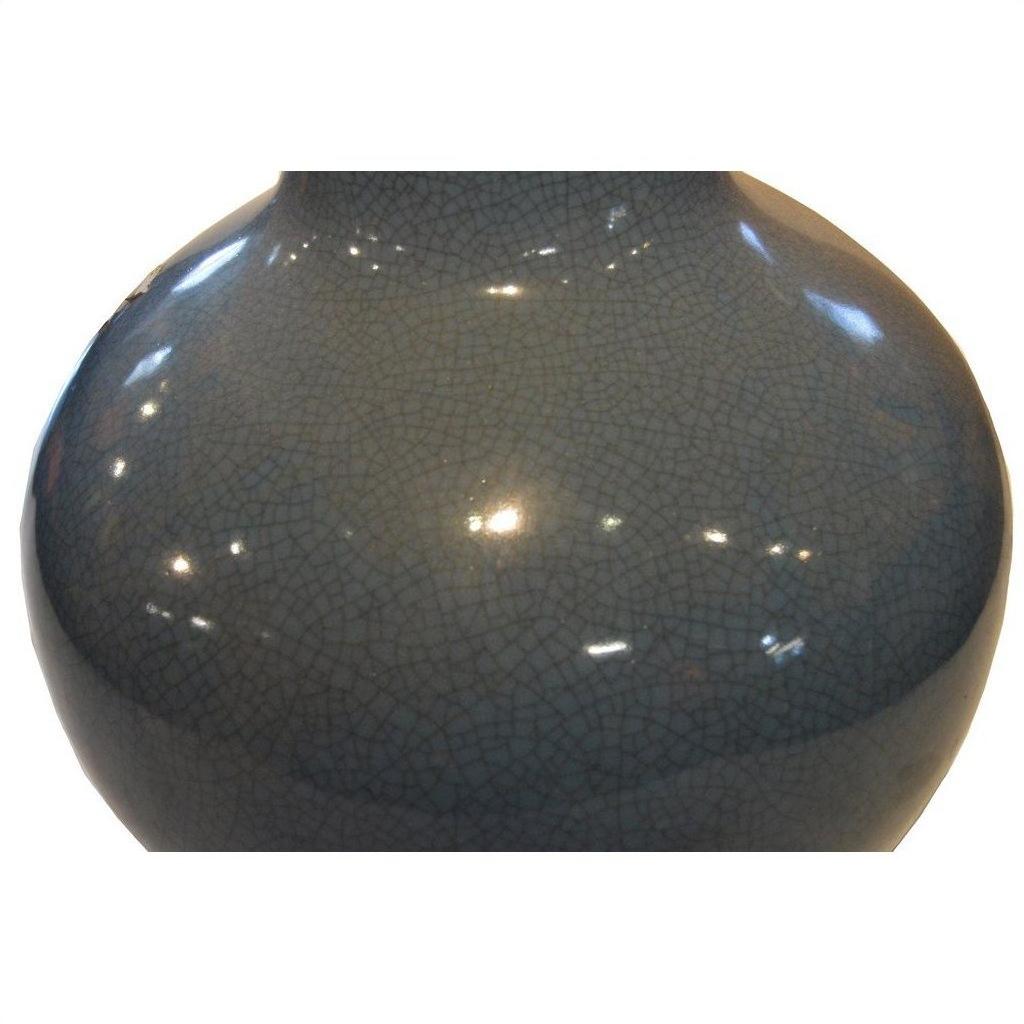 Close-up of a blue crackle celadon vase with glossy finish, showing crackle glaze details and light reflections.