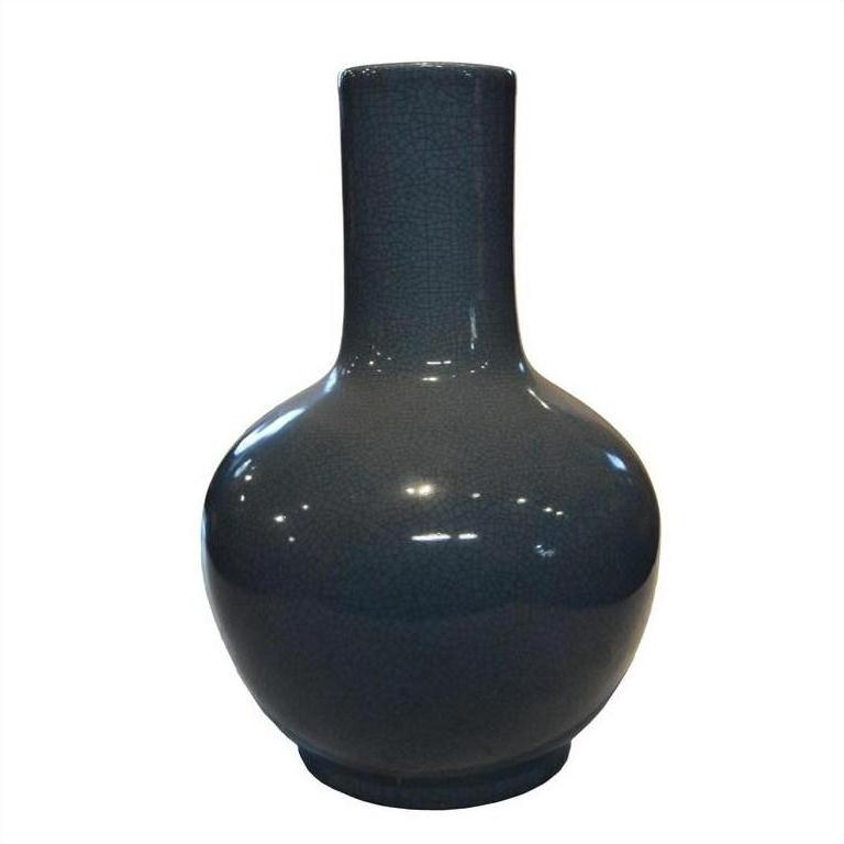 Close-up of a blue crackle celadon ceramic vase with a round body and tall narrow neck on a plain white background.