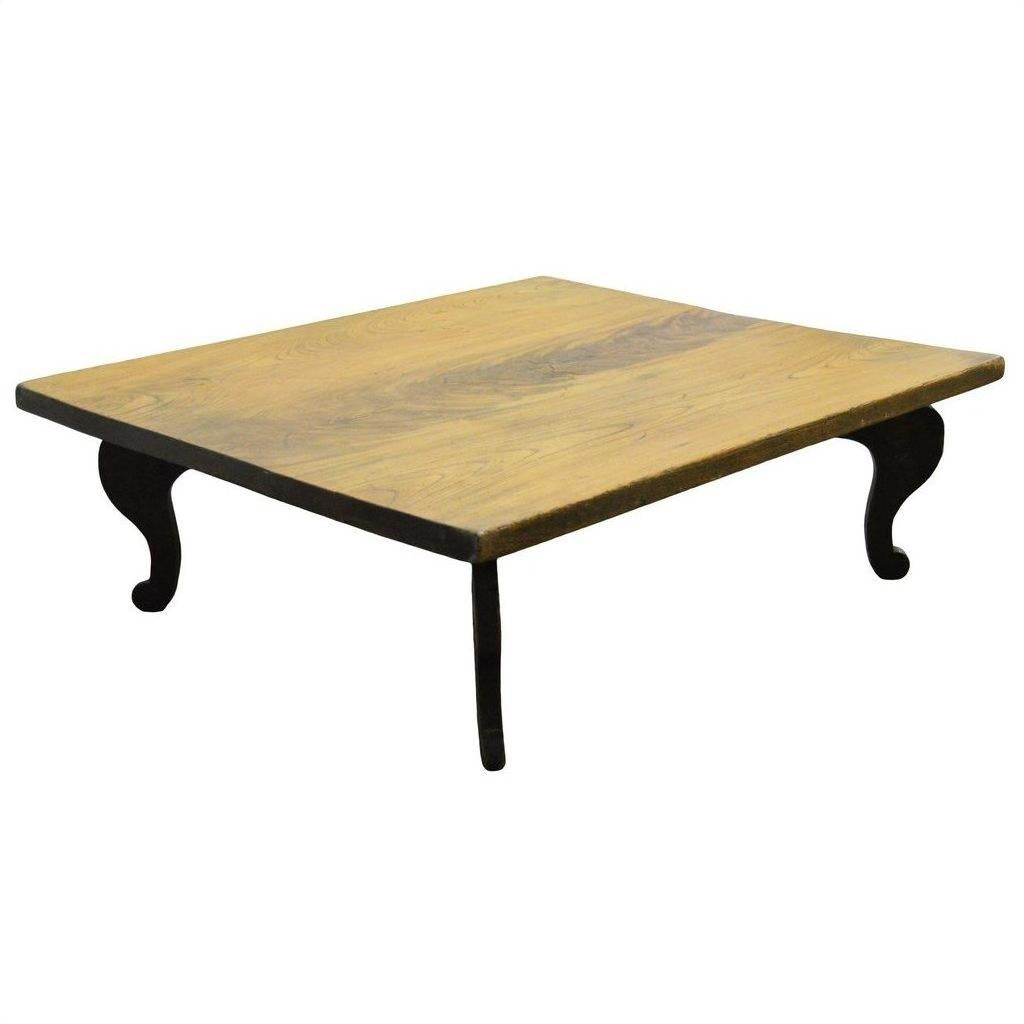Natural teak coffee table with curved legs on a white background, vintage Chinese style.