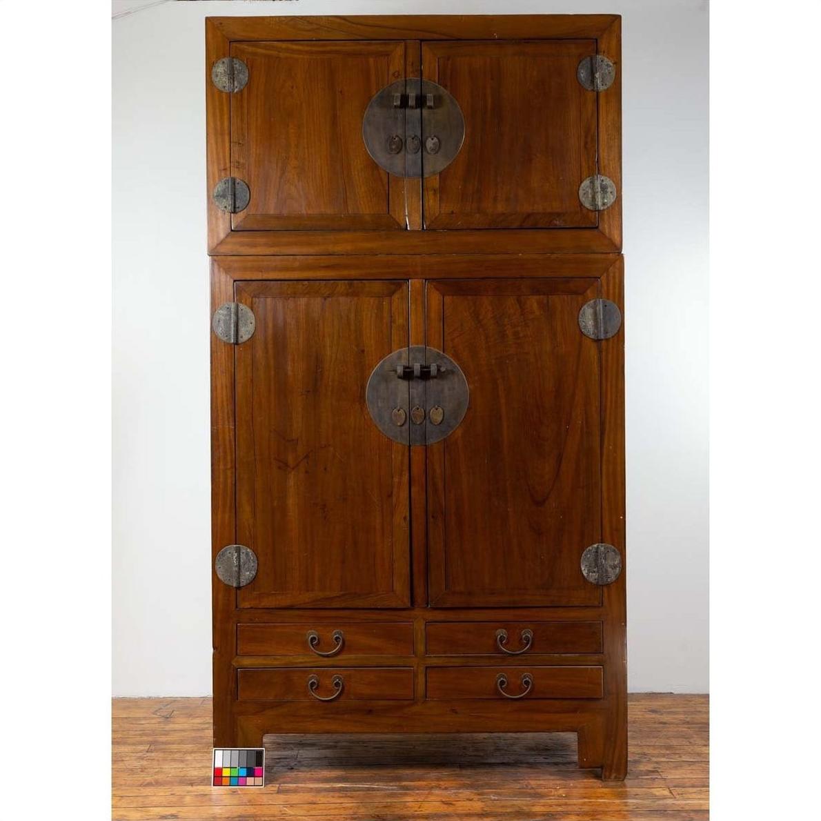 Brown Chinese elm wooden wardrobe with metal hinges, four doors, and four drawers, two-piece compound design.