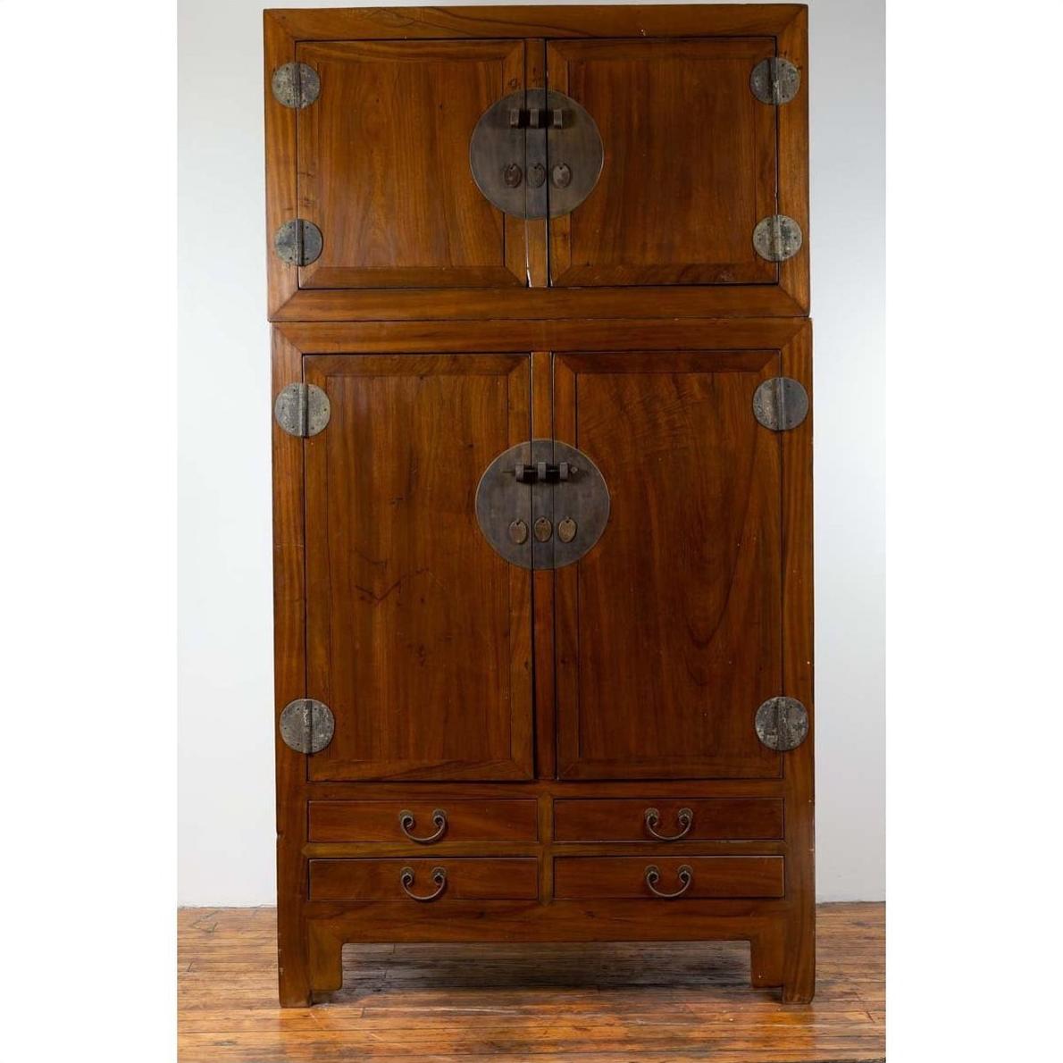 Brown Chinese elm wood wedding wardrobe with metal hinges, two sections, on a wooden floor.