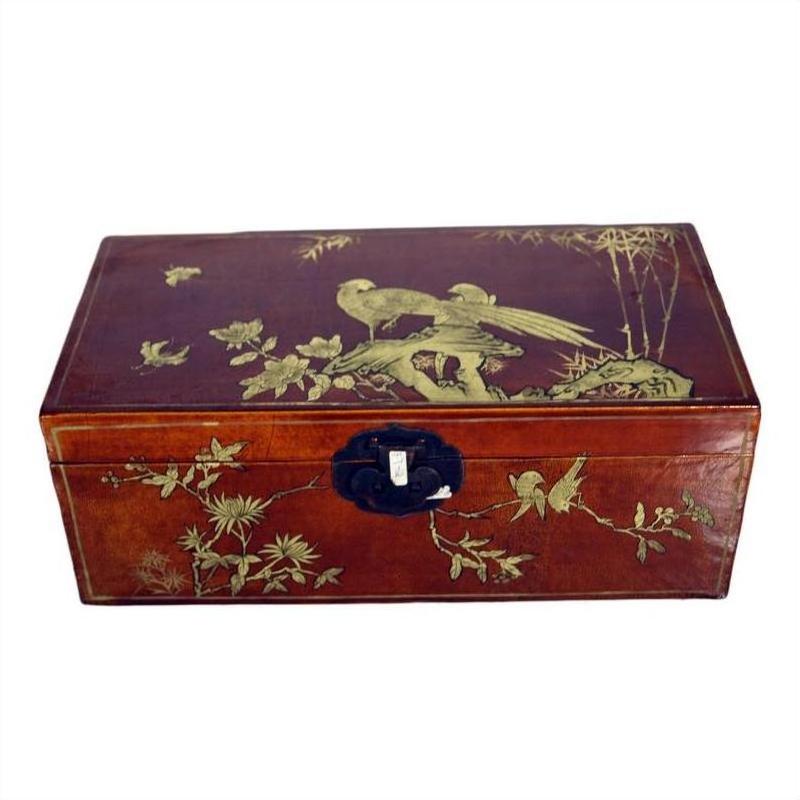 Black lacquered vintage Chinese dowry box with gold hand-painted bird and floral designs, black metal latch, close-up.