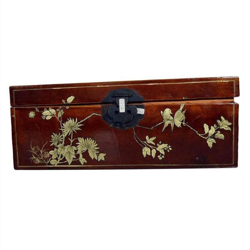Red lacquered Chinese wooden dowry box with hand painted floral and bird designs, black metal clasp, close-up view.