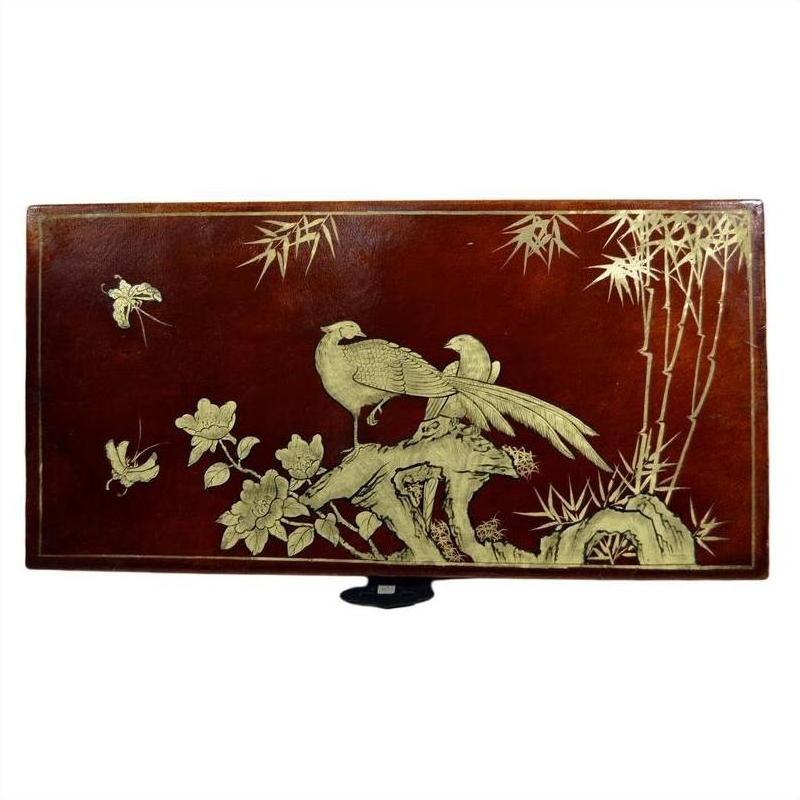 Brown lacquered Chinese dowry box with gold hand-painted birds, flowers, and bamboo on surface.