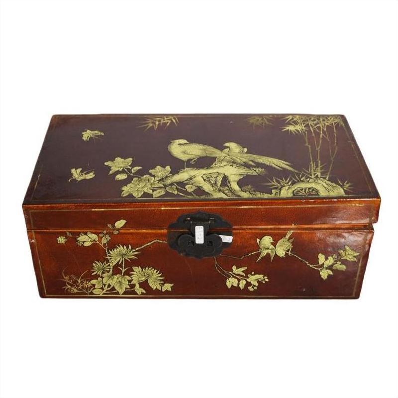 Black and gold lacquered wooden dowry box with hand painted bird and floral designs, close-up of decorative latch.