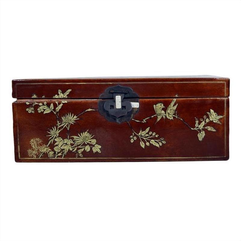 Black lacquered wooden Chinese dowry box with gold floral and bird designs, front metal latch, close-up view.