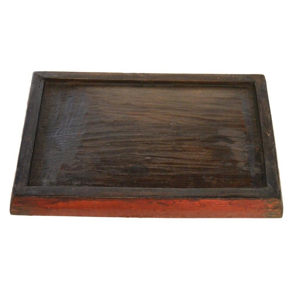 Close-up of vintage dark wood Chinese tray with raised edge and ornate hand-painted design, reddish-brown border visible.