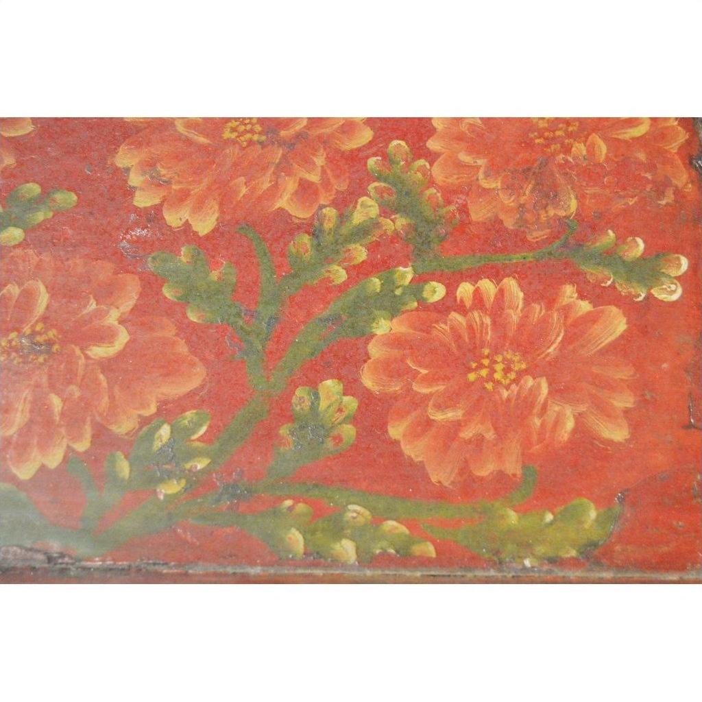 Red hand-painted Chinese tray with orange and yellow flowers, green stems; ornate floral design, close-up view.
