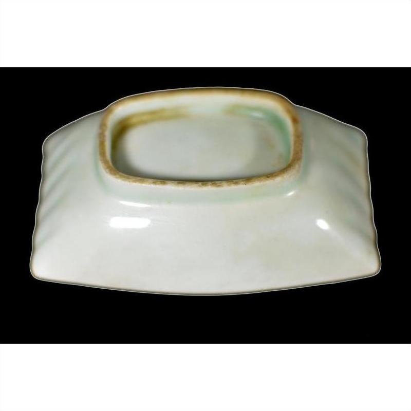 White porcelain dish with raised rim, hand painted in vintage Chinese style, glossy finish on black background.