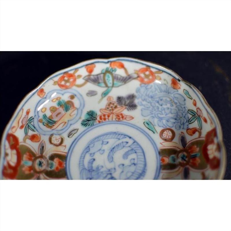 Close-up of colorful hand painted porcelain plate with intricate floral motifs and patterns, vintage Chinese style.