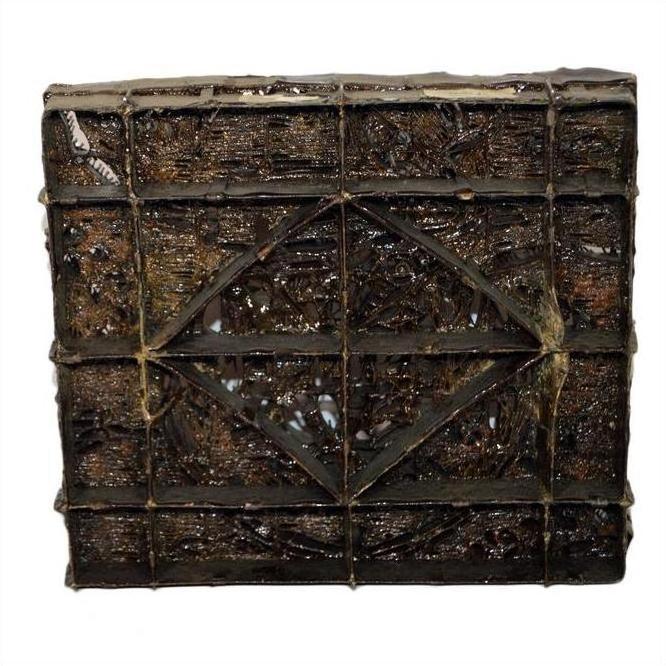 Close-up of a square, dark glossy chocolate-coated vintage copper Batek ink block with grid and diamond pattern.