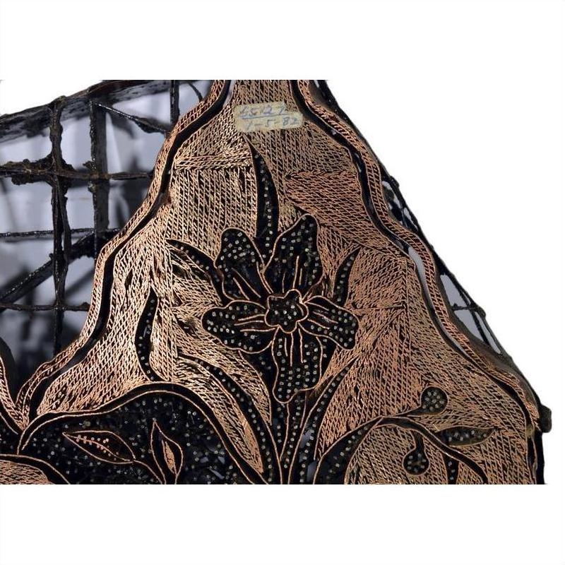 Close-up of vintage copper Batek ink block with intricate black and gold floral pattern on mesh.
