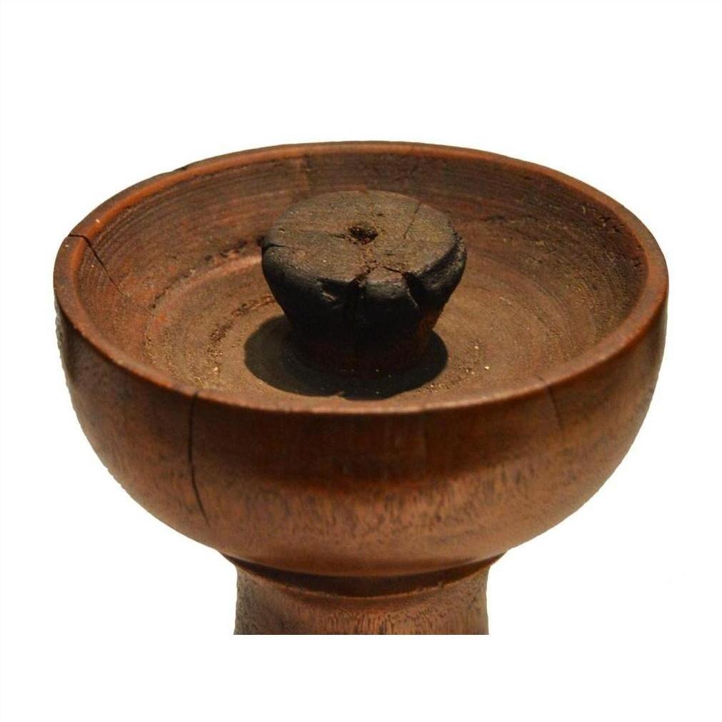 Close-up of a vintage hand-carved wooden candle holder with Dutch design on a white background.