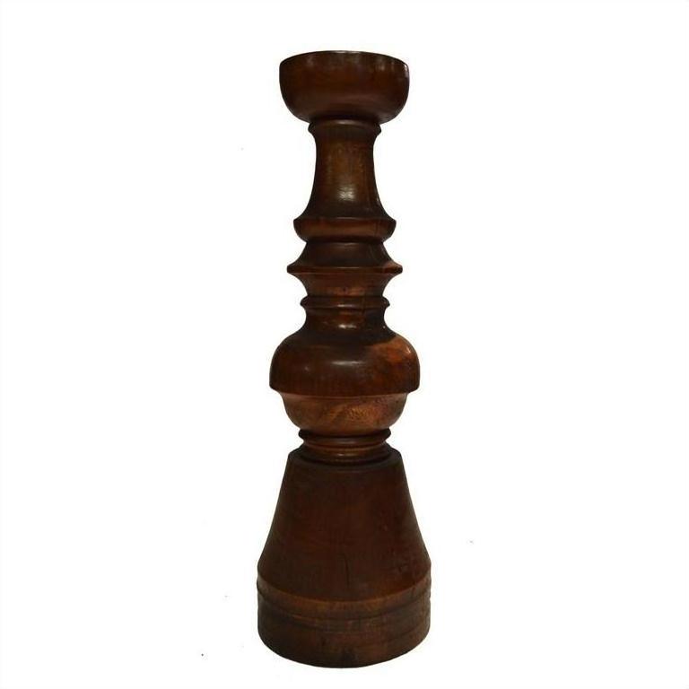 Brown hand-carved wooden candle holder with Dutch geometric design on a white background.