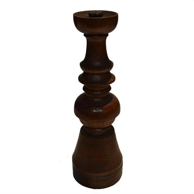 Close-up of a dark brown hand-carved wooden candle holder with vintage Dutch style on a white background.