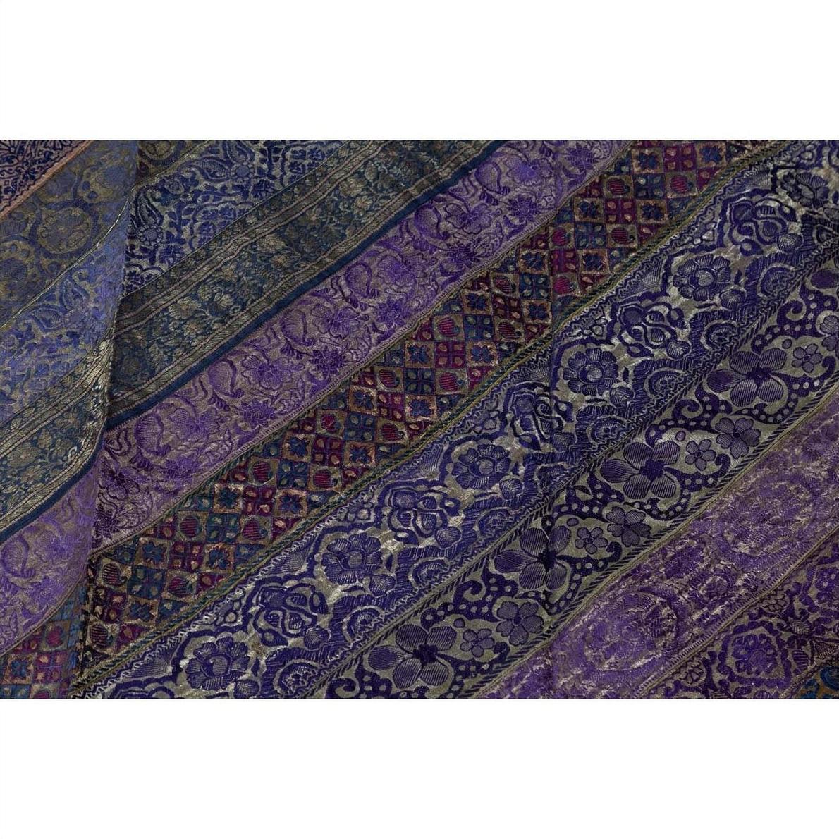 Close-up of purple silk fabric with silver and gold floral embroidery in diagonal stripes.