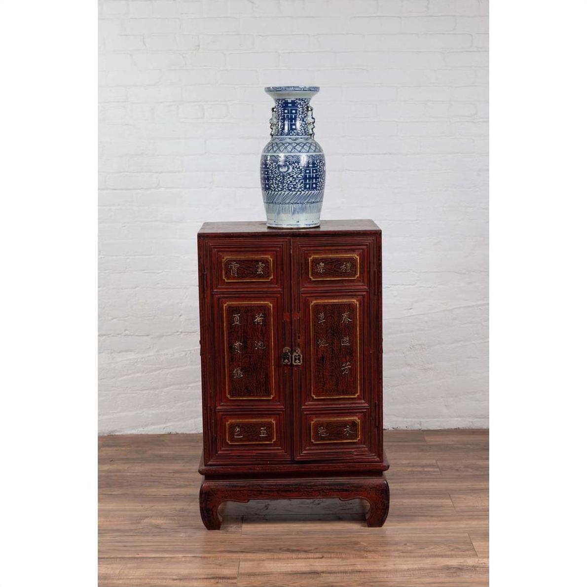 Blue and white porcelain vase on vintage Japanese display cabinet with red Negora lacquer and gilded calligraphy.