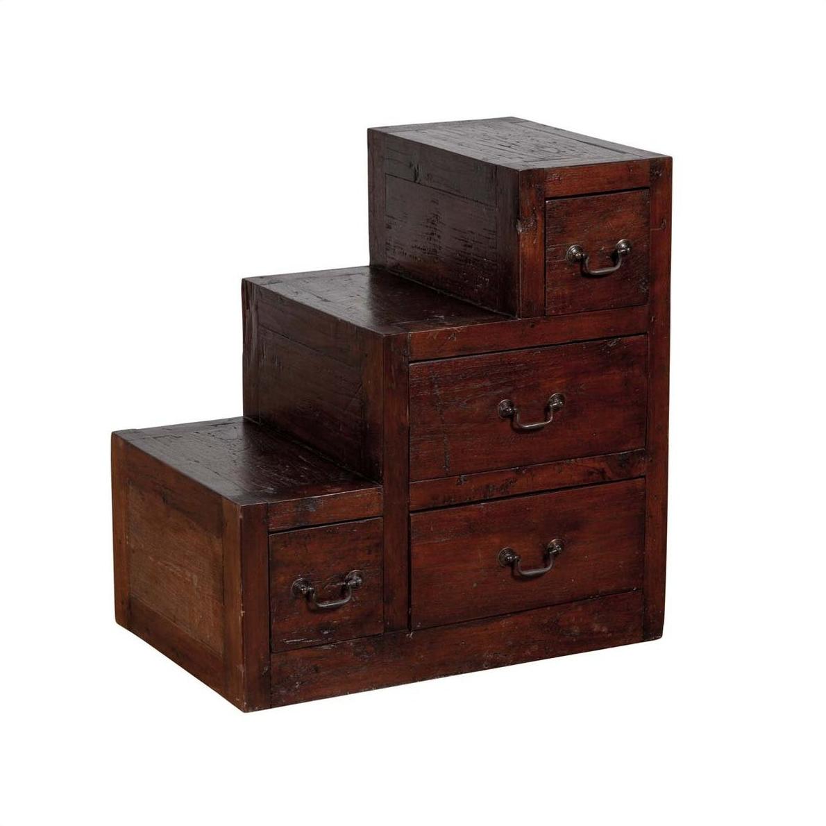 Brown wood staircase tansu cabinet with four drawers and metal handles, Japanese style, indoors.