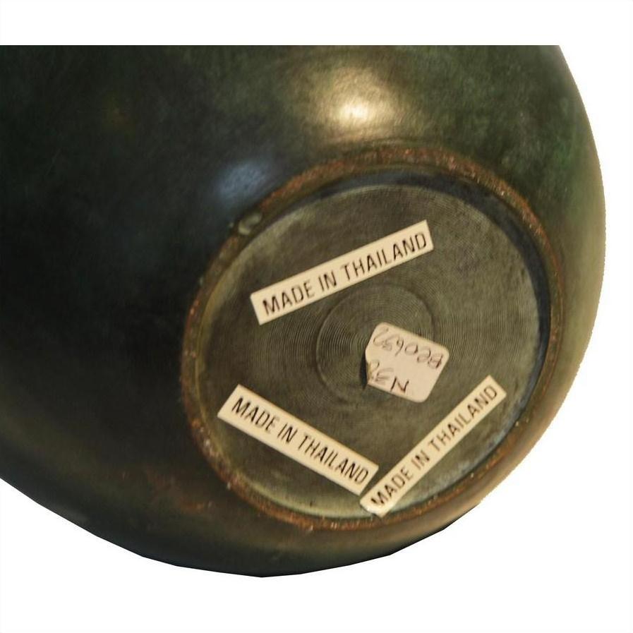 Close-up of vintage green bronze urn base with three MADE IN THAILAND labels and a small handwritten sticker.