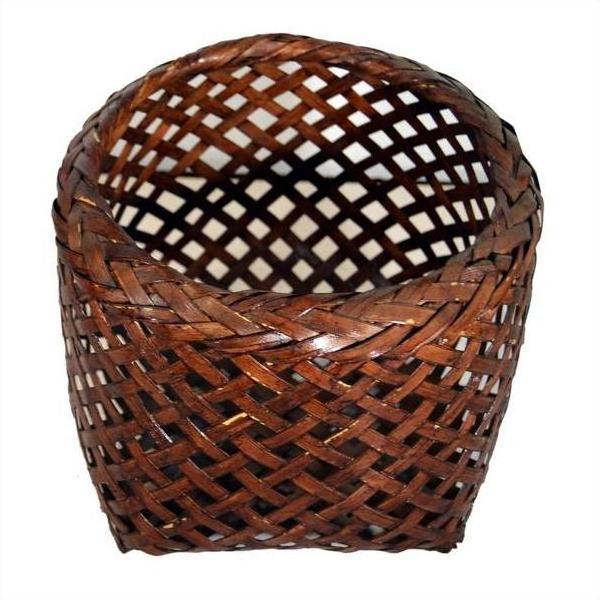 Brown rattan woven basket with open top and crisscross lattice design, vintage Thai style, close-up view.