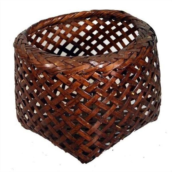 Brown rattan woven basket with a rounded top and pointed triangular base, vintage Thai design, close-up view.