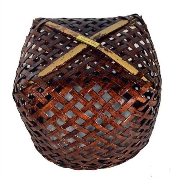 Brown rattan woven basket with rounded shape and open lattice design, vintage Thai style, close-up.