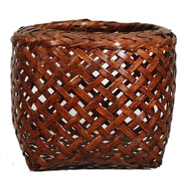 Brown rattan woven basket with open crisscross lattice design, vintage Thai style, close-up.