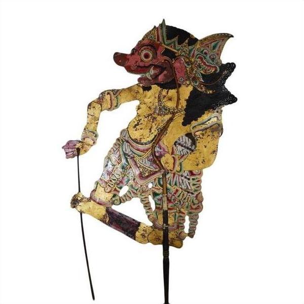 Tan cowhide Wayang Kulit shadow puppet with intricate carvings and two control sticks, classic Balinese style, close-up.