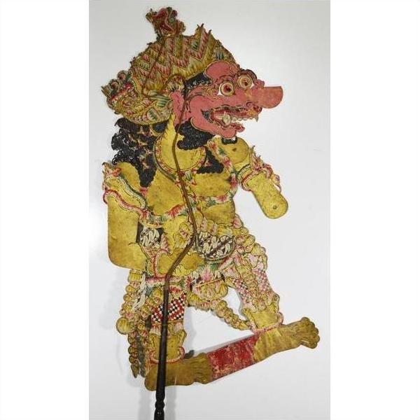 Colorful Balinese cowhide Wayang Kulit shadow puppet with ornate costume and exaggerated features on white background.