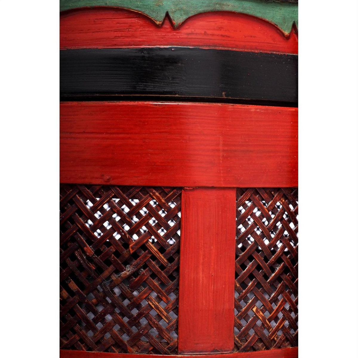 Close-up of red and black woven Wedding Basket with subtle green accents at the base.