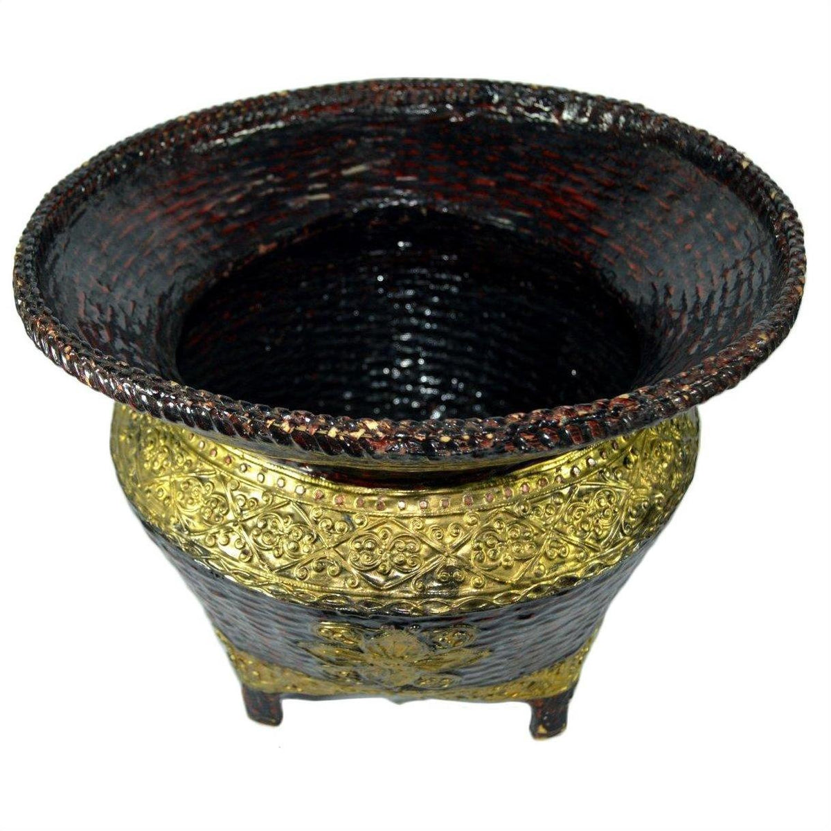 Close-up of ornate gold and black woven bamboo offering basket with gilt décor, wide rim, raised patterns, four short legs.