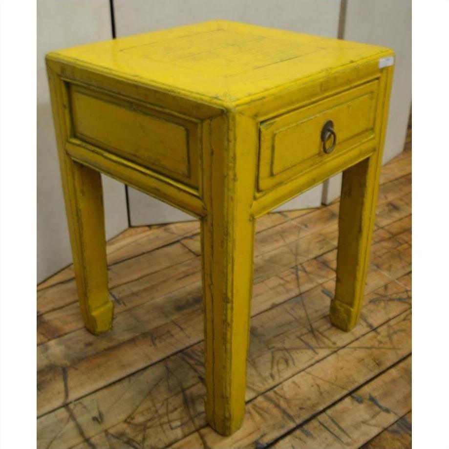 Yellow wood side table with horse hoof feet, single drawer, metal ring handle, and square legs, close-up view.