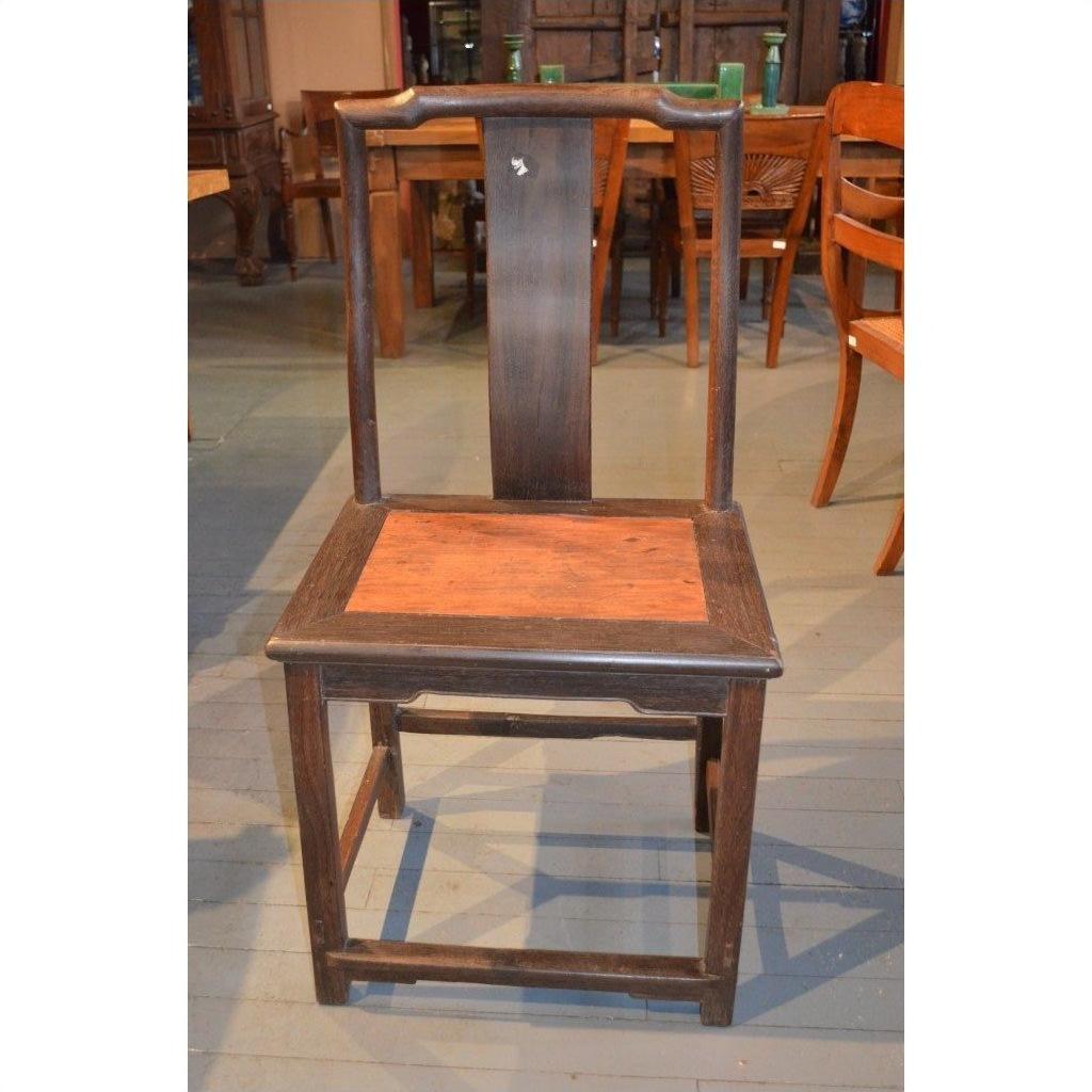 Dark brown Chinese yoke back chair with tall straight backrest and flat burl wood seat, front view.